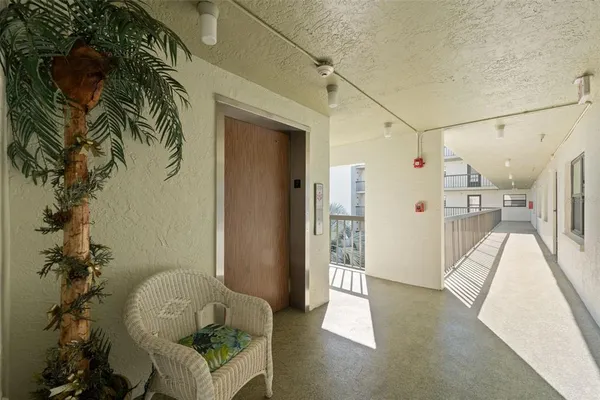 a view of an empty room with a fireplace and a ceiling fan