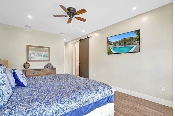 a bedroom with a large bed and a chandelier