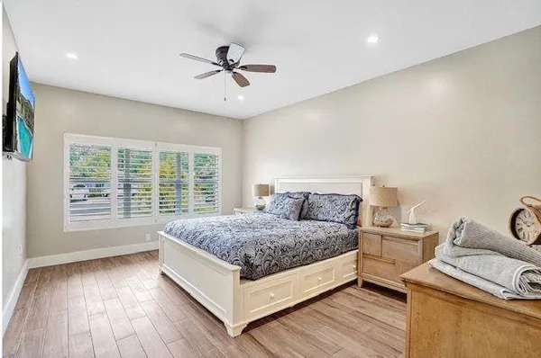 a living room with a bed furniture and a large window