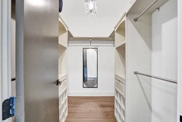 a view of staircase with railing and white walls