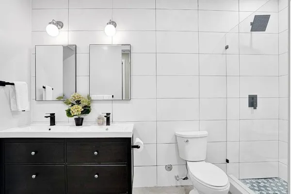 a bathroom with a sink vanity and toilet