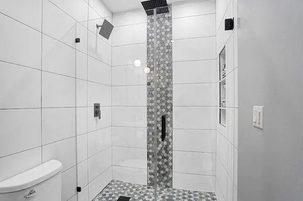 a bathroom with a toilet and a shower