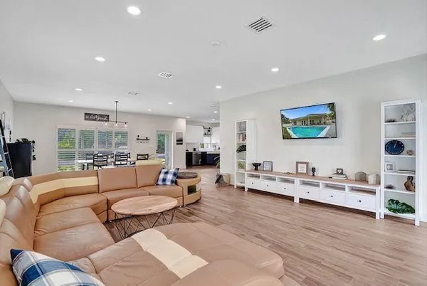 a living room with furniture and wooden floor