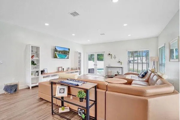 a living room with furniture and a wooden floor