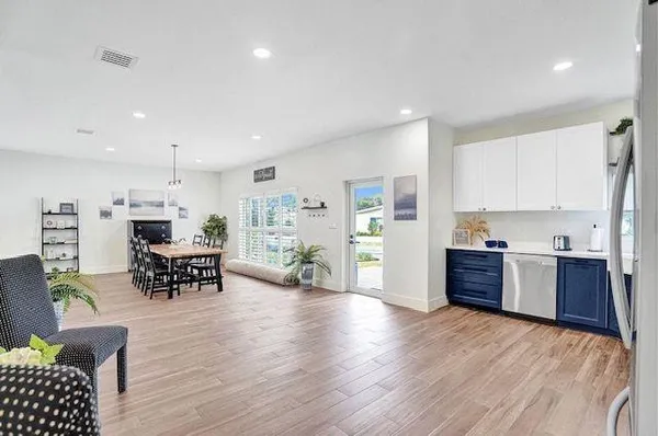 a living room with furniture and kitchen view