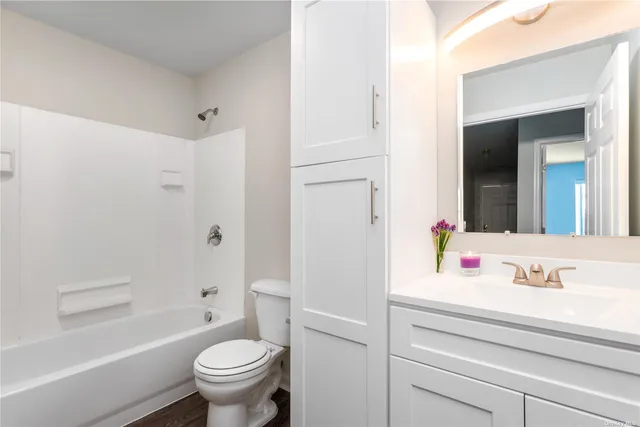 a bathroom with a sink toilet vanity and shower