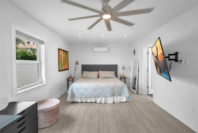 a bedroom with a large bed and a chandelier