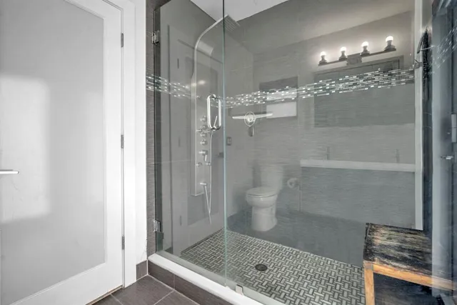 a bathroom with a glass shower door