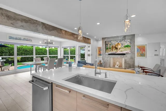 a view of a kitchen with a sink and large window