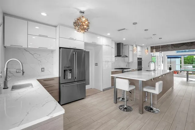 a kitchen with granite countertop a refrigerator and a sink