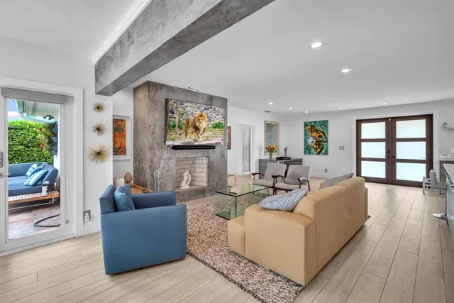 a living room with fireplace furniture and a flat screen tv
