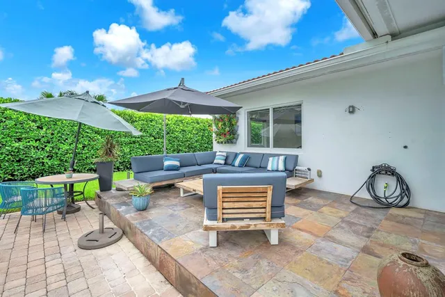 a view of a house with backyard and sitting area