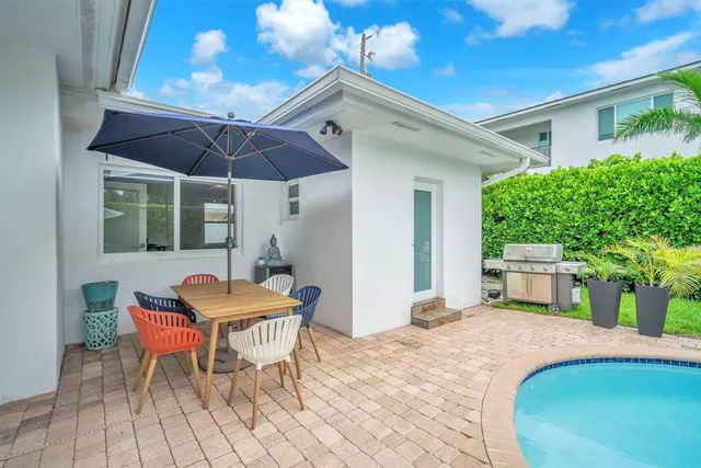 a outdoor space with a table and chairs