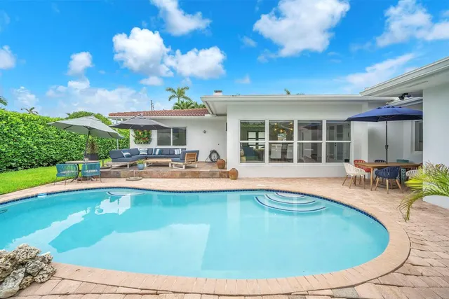a view of swimming pool with outdoor seating