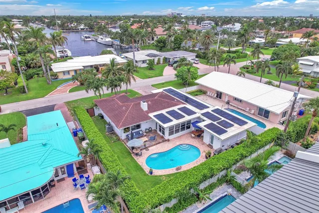 an aerial view of a house with a big yard