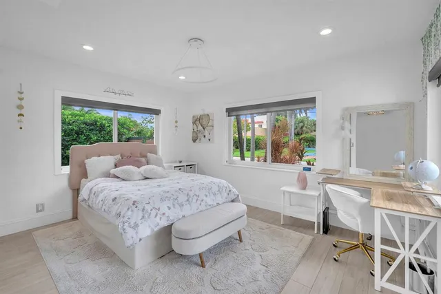 a living room with a bed furniture and a large window