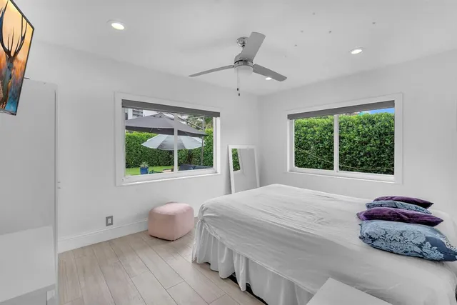 a bedroom with a bed and a large window