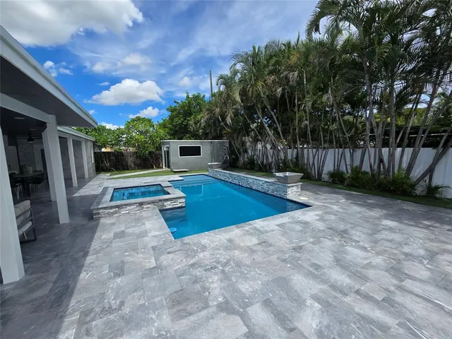 a view of a backyard with swimming pool