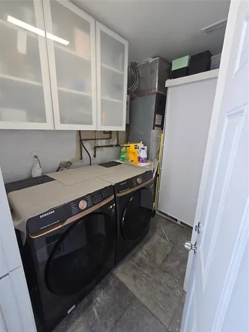 a utility room with sink dryer and washer