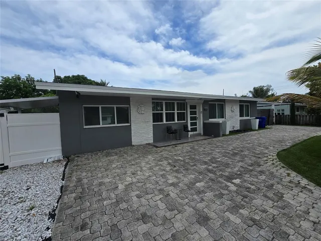 a view of a house with backyard porch and sitting area
