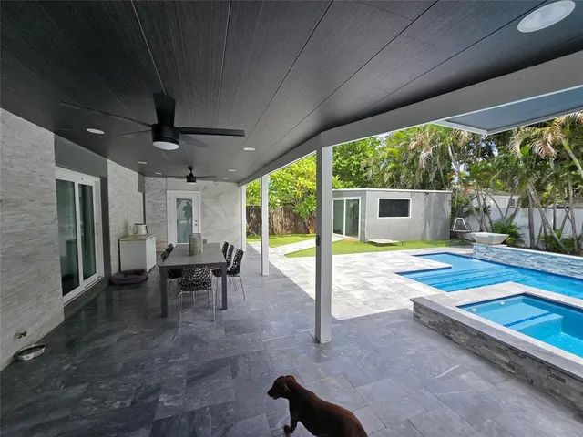 a view of a porch with chairs and backyard