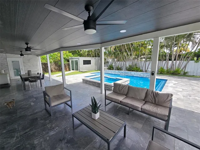 a living room with furniture and a floor to ceiling window