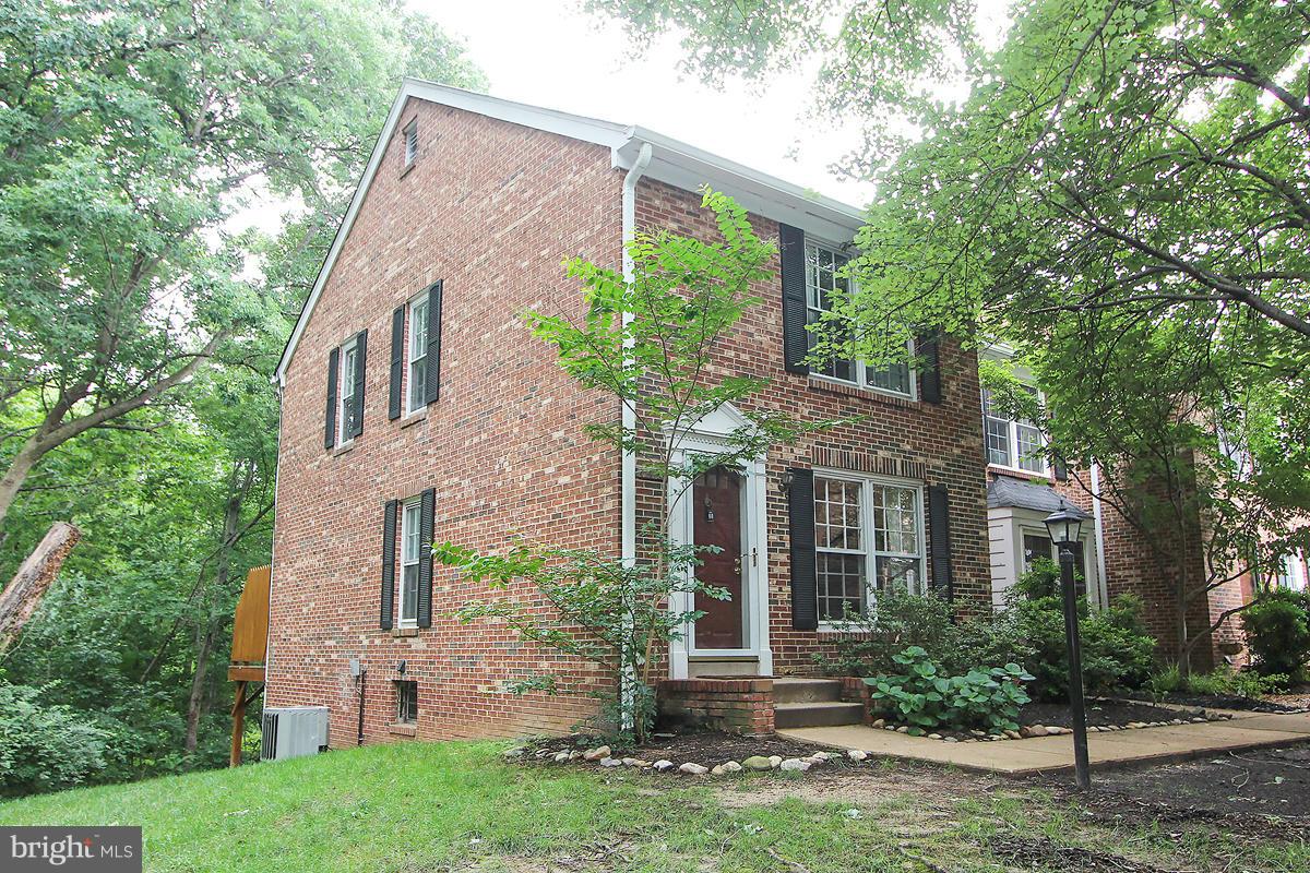 2428 South Walter Reed Drive, Unit A Arlington, VA 22206 - Photo 2 of 30 a front view of a house with a yard and potted plants
