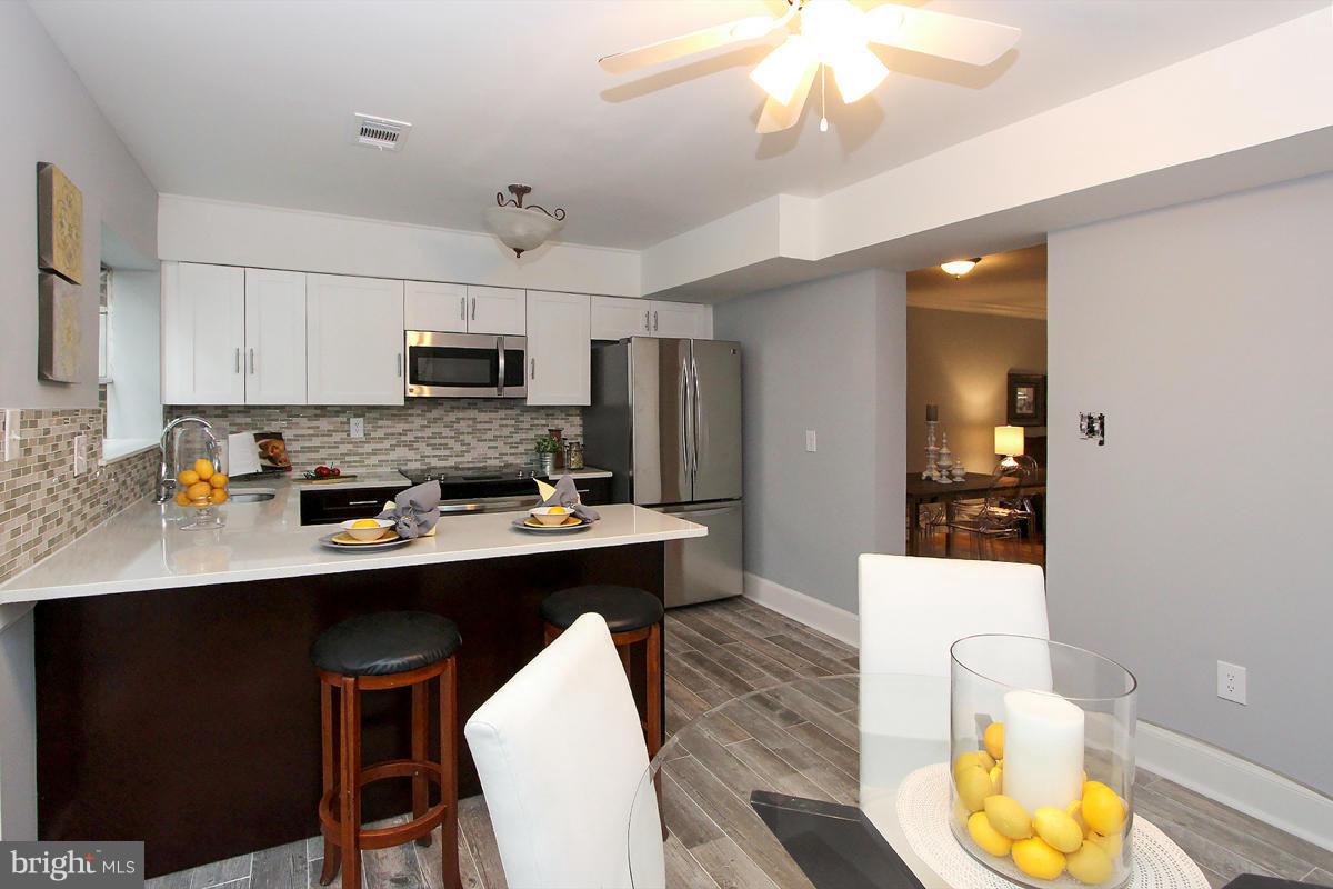 2428 South Walter Reed Drive, Unit A Arlington, VA 22206 - Photo 12 of 30 a kitchen with stainless steel appliances a sink stove and refrigerator