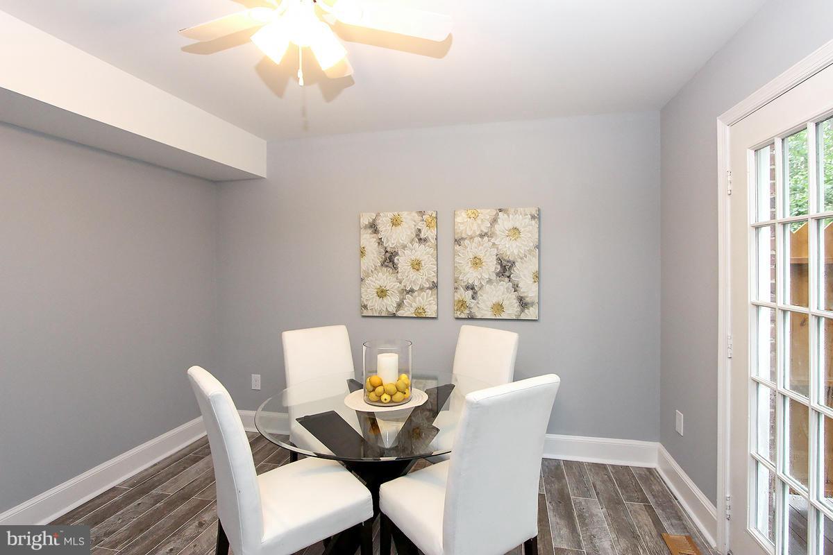 2428 South Walter Reed Drive, Unit A Arlington, VA 22206 - Photo 17 of 30 a view of a dining room with furniture and wooden floor