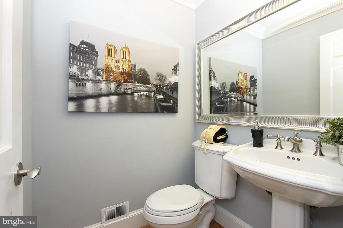 2428 South Walter Reed Drive, Unit A Arlington, VA 22206 - Photo 19 of 30 a bathroom with a sink a mirror and a toilet