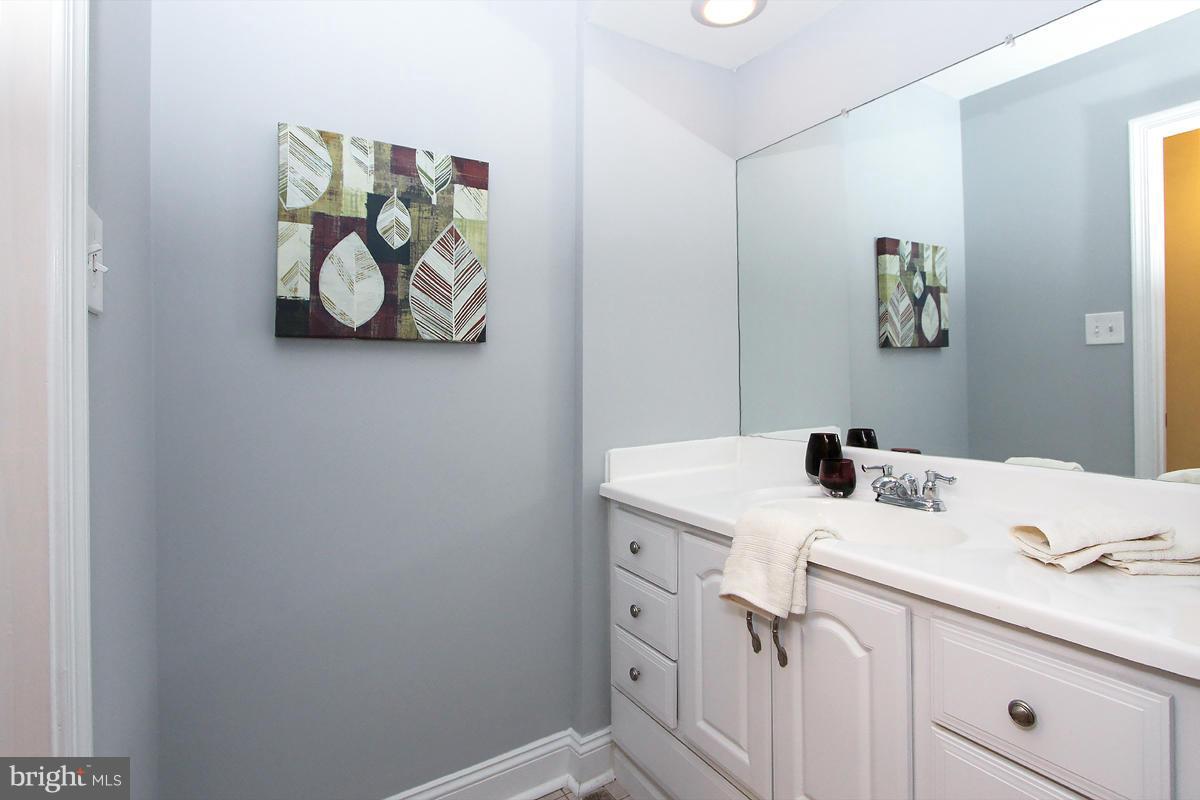 2428 South Walter Reed Drive, Unit A Arlington, VA 22206 - Photo 22 of 30 a bathroom with a sink mirror and vanity