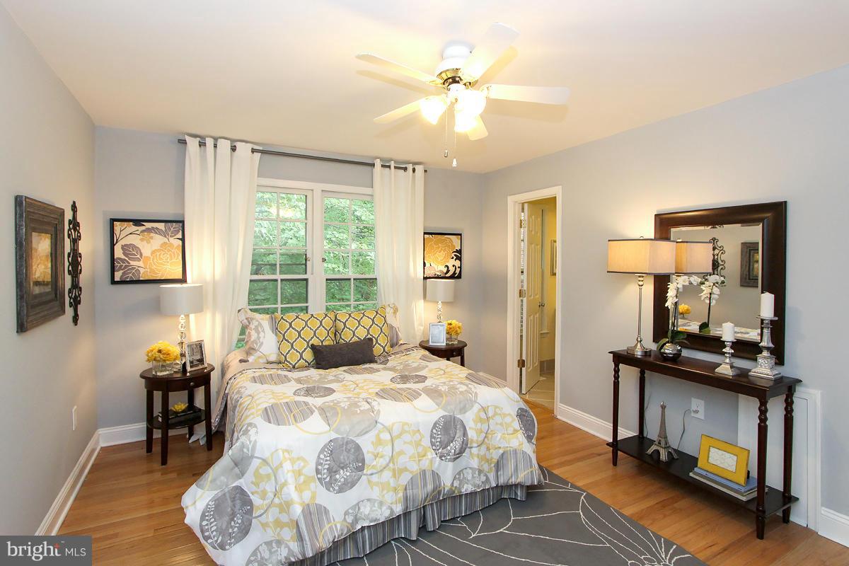 2428 South Walter Reed Drive, Unit A Arlington, VA 22206 - Photo 25 of 30 a bedroom with a bed a window and a chandelier