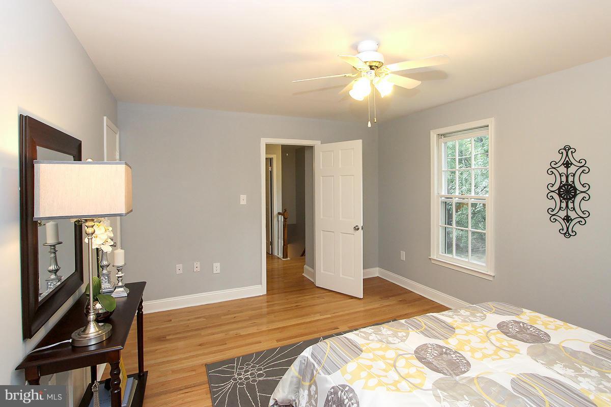 2428 South Walter Reed Drive, Unit A Arlington, VA 22206 - Photo 26 of 30 a bedroom with a bed and a chandelier