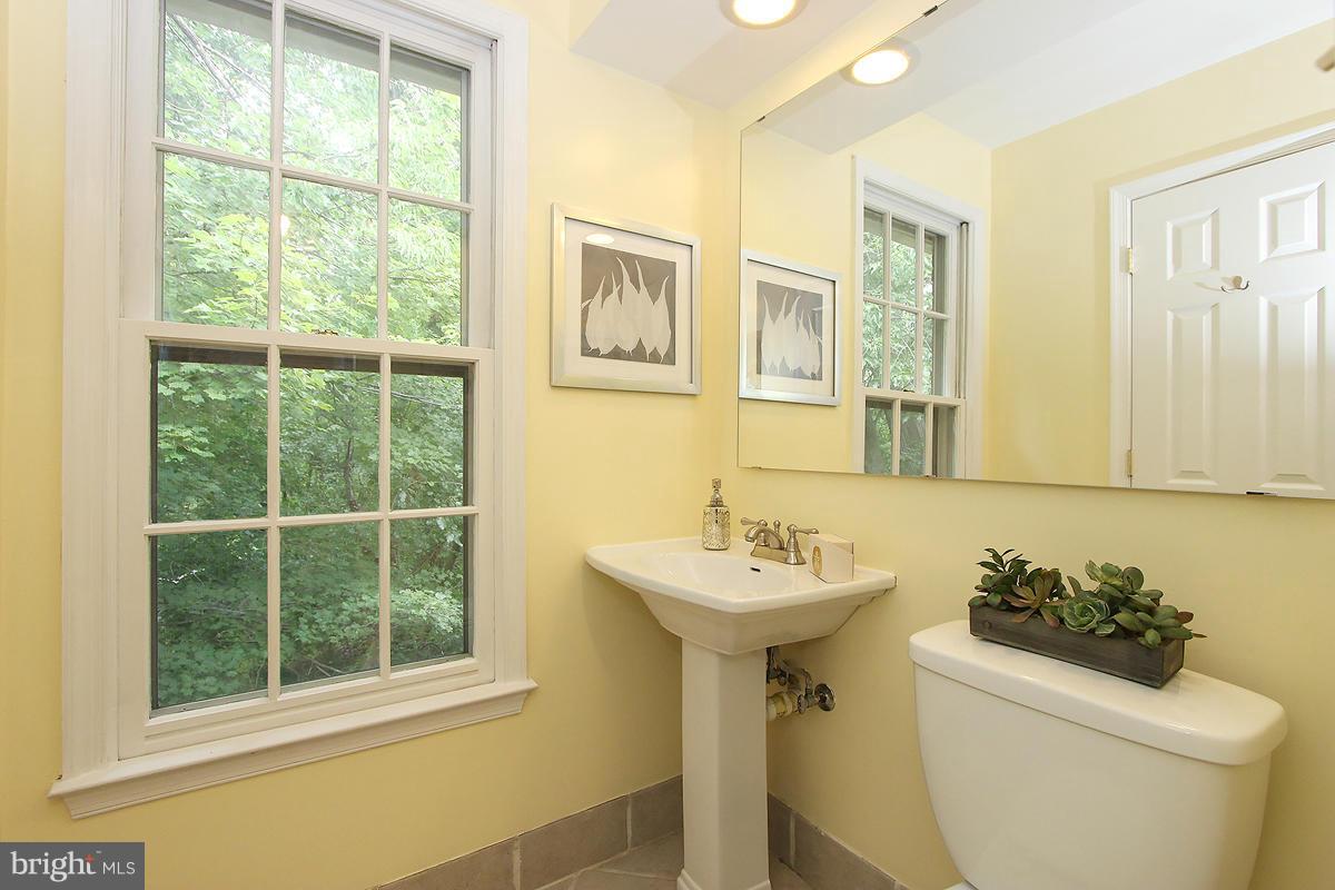 2428 South Walter Reed Drive, Unit A Arlington, VA 22206 - Photo 27 of 30 a bathroom with a sink toilet and a mirror