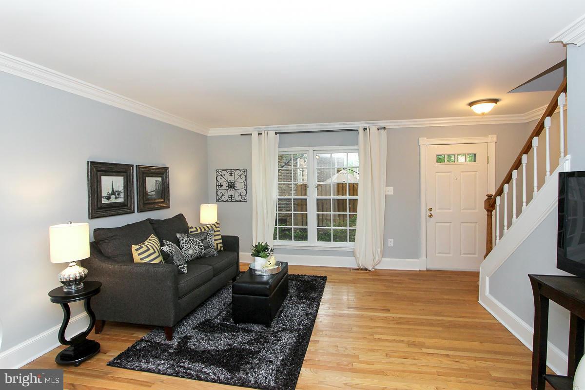 2428 South Walter Reed Drive, Unit A Arlington, VA 22206 - Photo 6 of 30 a living room with furniture and a rug