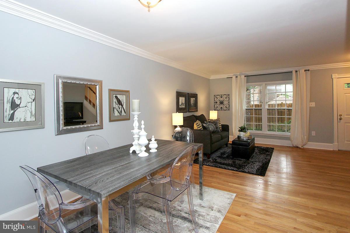2428 South Walter Reed Drive, Unit A Arlington, VA 22206 - Photo 9 of 30 a living room with furniture two window and a table