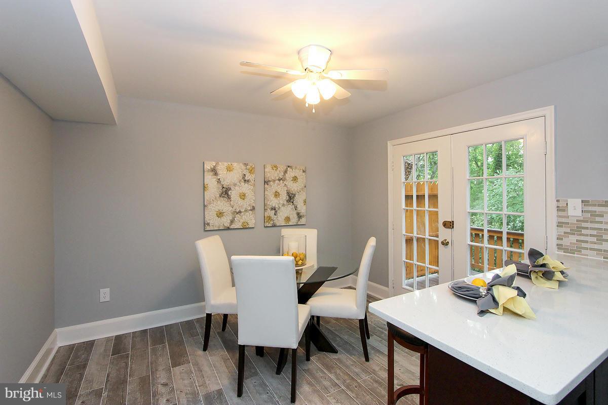 2428 South Walter Reed Drive, Unit A Arlington, VA 22206 - Photo 10 of 30 a view of a dining room with furniture a chandelier and wooden floor
