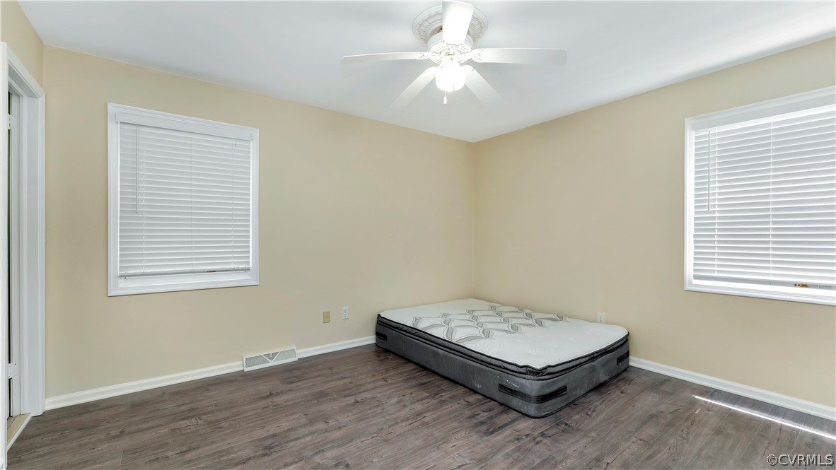 6212 Barrister Road Chesterfield, VA 23832 - Photo 8 of 19 a room with wooden floor and a ceiling fan