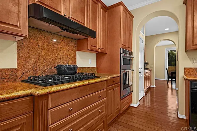 a stove top oven sitting inside of a kitchen