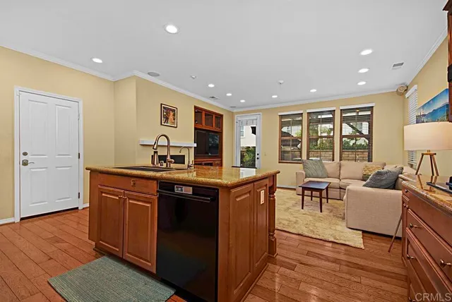 a kitchen with stainless steel appliances granite countertop a sink and a stove