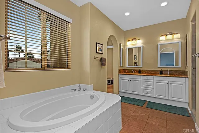 a spacious bathroom with a bathtub and a sink
