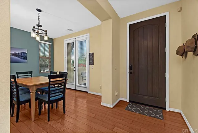 a view of a dining room with furniture wooden floor and a chandelier