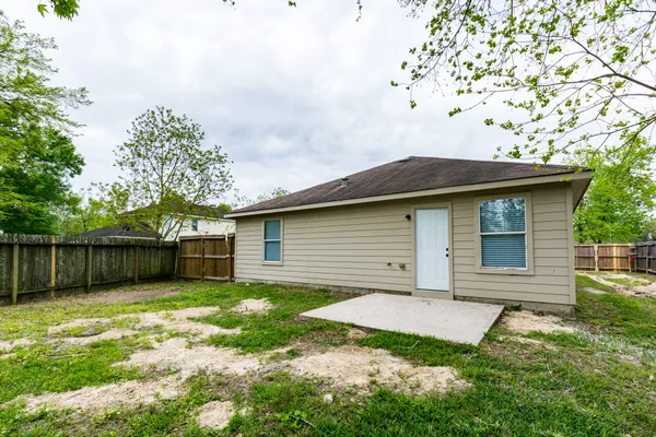 a view of a small house with a yard