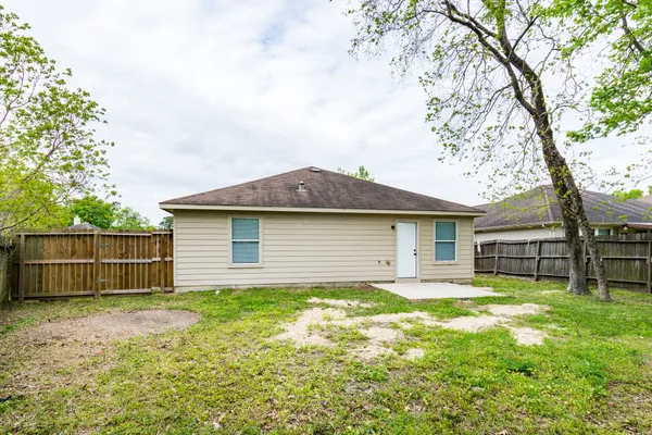 a view of a house with a yard and sitting area