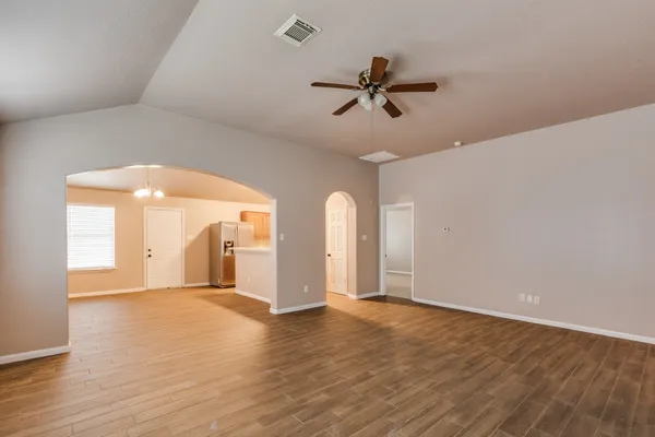 a view of a livingroom with a ceiling fan and wooden floor