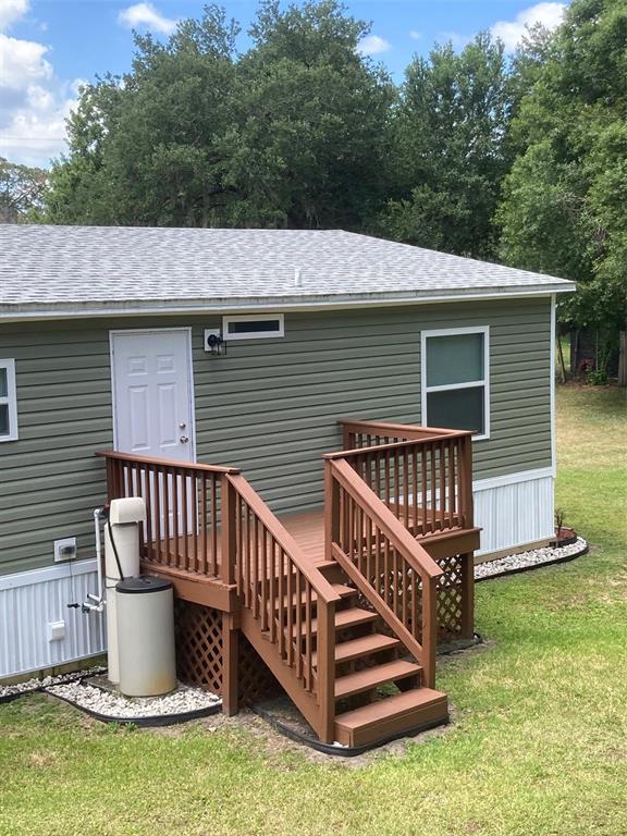 18137 Hollister Road Orlando, FL 32820 - Photo 25 of 27 a view of a house with wooden deck and a yard