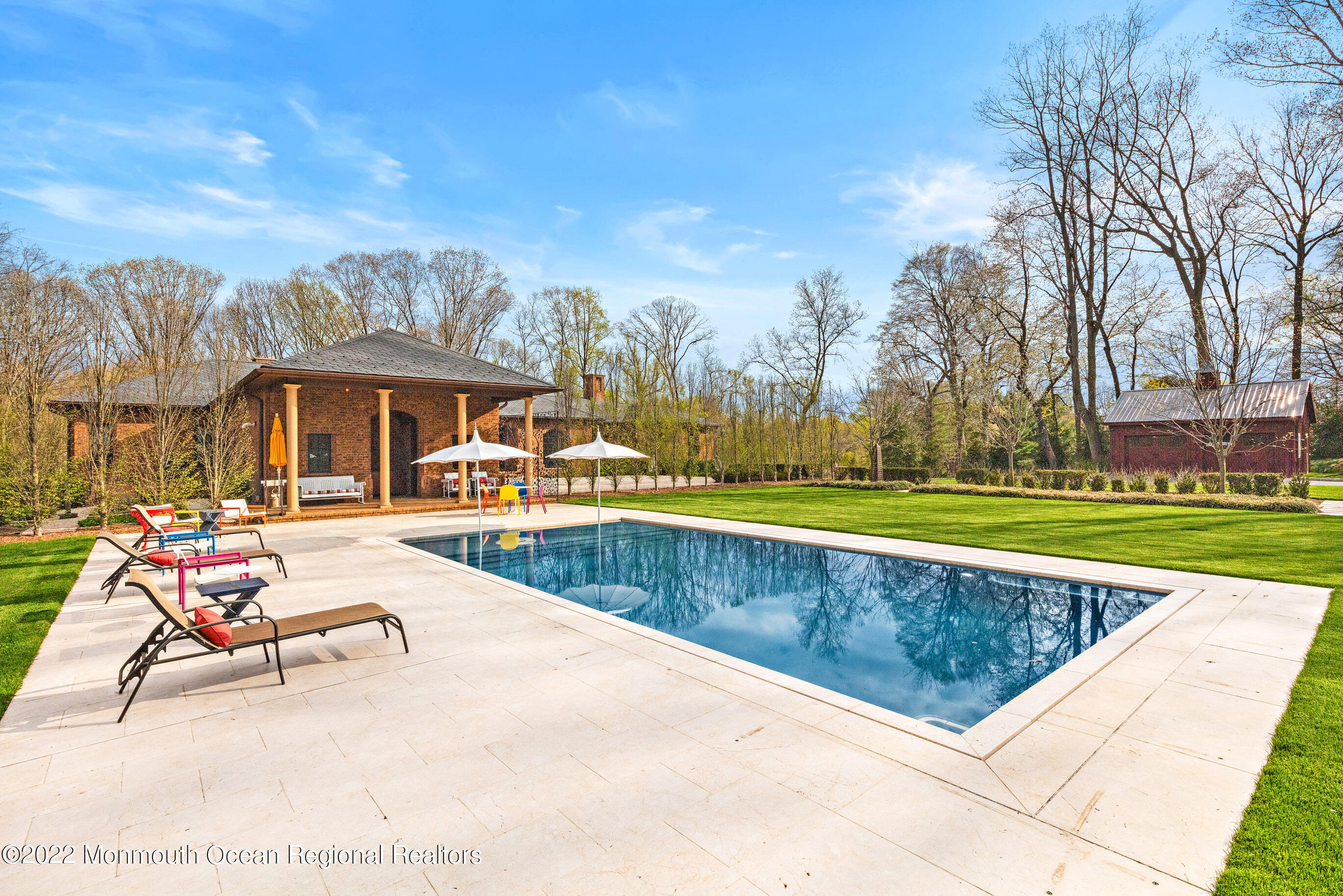 8 Edgewood Road Rumson, NJ 07760 - Photo 25 of 31 a view of swimming pool with lounge chair and dinning table under an umbrella