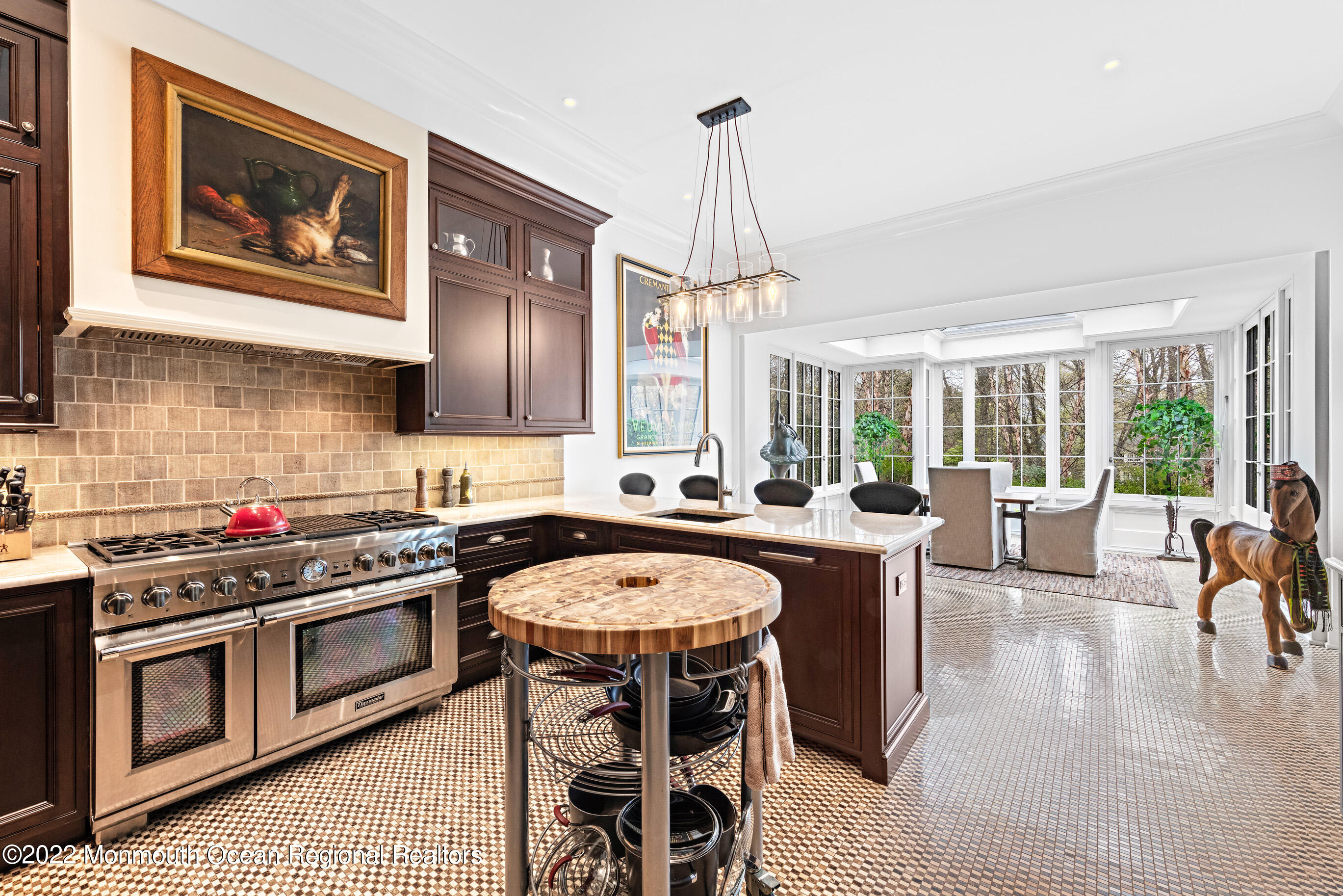 8 Edgewood Road Rumson, NJ 07760 - Photo 10 of 31 a kitchen with stainless steel appliances granite countertop a stove top oven a sink a dining table and chairs with wooden floor