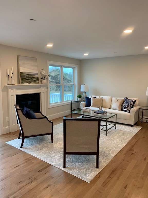 4 Putnam Road Hudson, NH 03051 - Photo 4 of 11 a living room with furniture and a fireplace