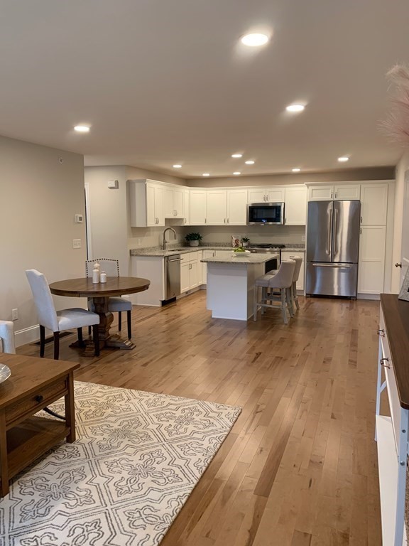 4 Putnam Road Hudson, NH 03051 - Photo 10 of 11 a living room with dining room and kitchen view